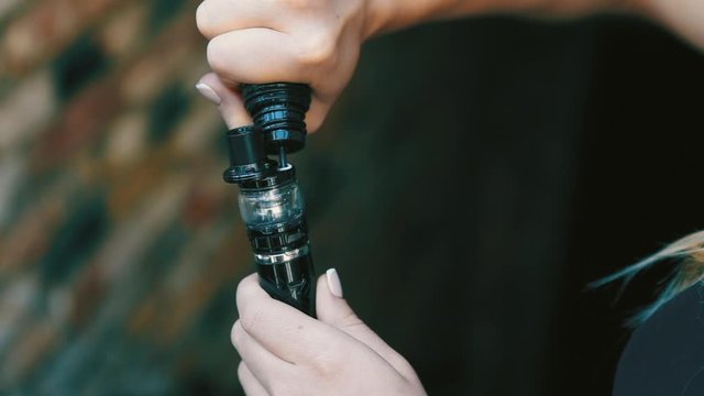 Vape Brown Tobacco Juice Tank Refill. Vaping eCigarette Tools in Background.