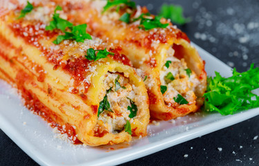 Stuffed cannelloni with ricotta cheese and tomato sauce.