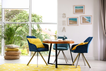 Modern dining room interior with served table and chairs