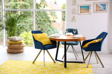 Modern dining room interior with served table and chairs