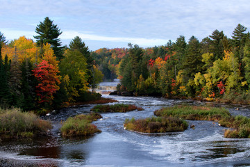 autumn landscape with river, waterfall, and trees