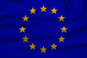 stylized European Union flag, symbol of united Europe on soft silk with soft folds, close-up