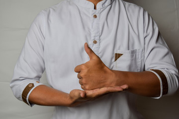 Close up Asian man shows hand gestures it means HELP isolated on white background. American sign...