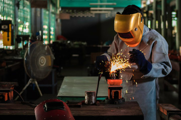 A craftman is welding with workpiece steel.Working person About welder steel Using electric welding...