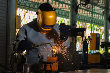 Metal industry welders in industrial plants Standard protective equipment, gloves and masks.