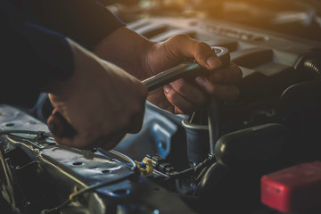 A mechanic working in garage. Repair service.