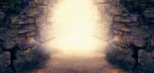 Mysterious fantasy photo background, magical trail leading out through stone dungeon cave walls towards mystical glow. Idyllic tranquil fantastic scene, empty road, way to fairytale, copy space. - obrazy, fototapety, plakaty