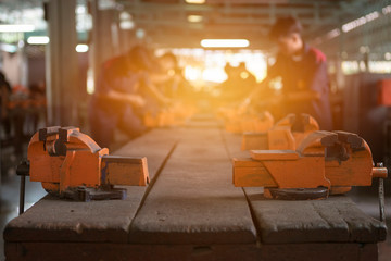 Men are using rasp the hammer to sharpen and put the hammer in factory with industry. Image is blur