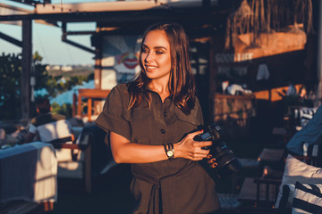 Beauty brunette woman posing in the street, make photo, using photo camera, outdoor hipster portrait, photographer, Thailand, sunglasses, photographer, travel blogger, watch, cafe, happy face, smile