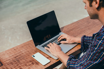 Pretty Young Handsome Man Using Laptop in cafe, outdoor portrait business man, hipster style,...