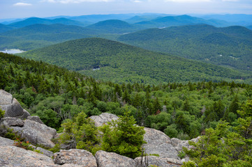 Beautiful landscape from the Crane Mountain summit in the Adirondack Mountains; overcast sky and blue mountain ranges in the distance