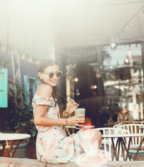 Woman drinking vegetable smoothie after fitness running workout on summer day. Fitness and healthy lifestyle concept, outdoor close up portrait, hipster, juice, tasty, sweet, sunglasses