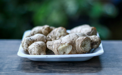 Ginger or Zingiber officinale on wood background. Used as a spice and a folk medicine.