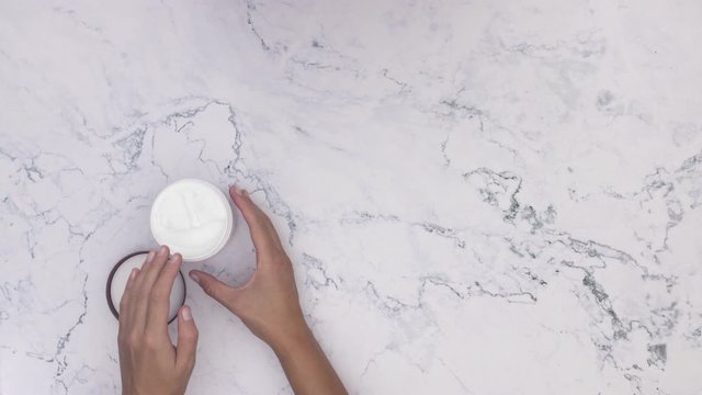 Stop motion animation of woman's hand grease hand creme 