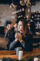 A beautiful girl in a beige jacket drinks coffee from a glass talking on the phone, wearing sunglasses works in the office in the business center, the manager, the employee of the company, happy face