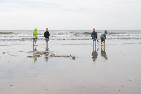 Brothers Playing in the Water at the Beach