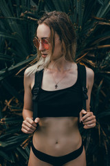 Obraz na płótnie Canvas Woman beach photo portrait, backpack travel girl,Pretty woman posing in the park, using backpack, travel vibes, hipster girl, outdoor close up portrait, happy face, smile, swimsuit, cap, smile, Bali