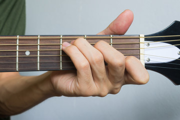 Guitar Player Hand in C Major Chord on Acoustic Guitar in Front View