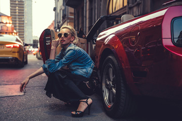 Beauty woman posing with red car in the street,fashion model,outdoor crazy portrait,Single laughing...