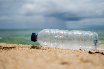 plastic bottle on the beach pollution and environment  conceptual