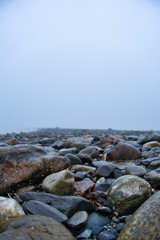 Outside nature photo featuring close up rocks and fog.