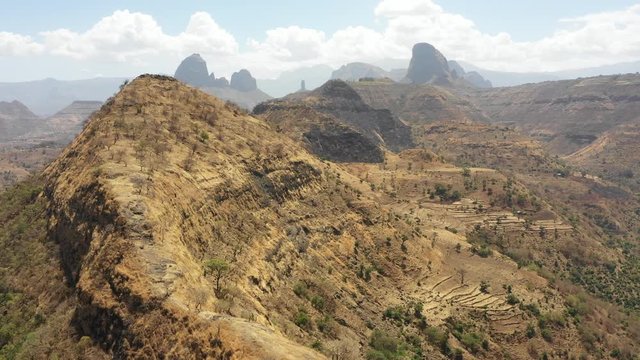 Flying over mountain ridge towards surreal pinnacle landscape of Simien national park, popular tourist destination in Northern Ethiopia Africa