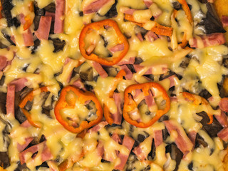 Background of fresh homemade pizza decorated with rings of bell pepper. The view from the top.