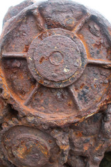 Outside nature photo featuring a car part that is rusty