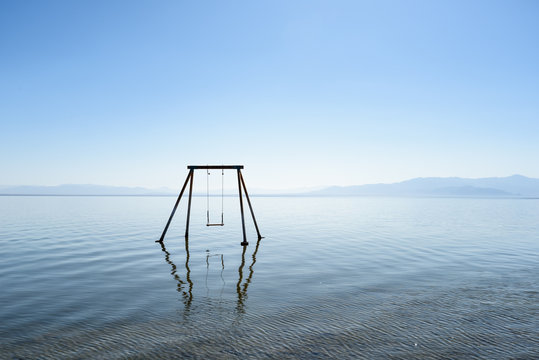 Abandoned swing in the water at Bombay beach, Salton Sea, California