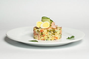 Russian salad on a white plate
