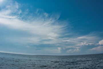 Fototapeta na wymiar Outside nature photo featuring - clouds and ocean