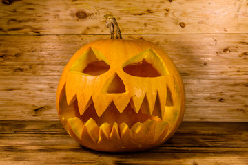Spooky halloween pumpkin on a wooden table