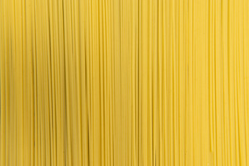 Raw Italian spaghetti pasta on gray background