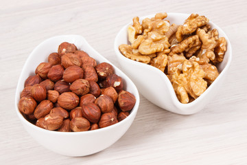 Hazelnuts and walnuts in bowl as source healthy vitamins and minerals, nutritious eating
