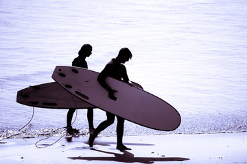 Surfing silhouette surfer man wearing wetsuit surf in tamraght taghazout agadir morocco  © youness fakoiallah