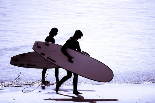 Surfing silhouette surfer man wearing wetsuit surf in tamraght taghazout agadir morocco 