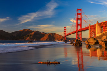 Golden Gate Bridge view from the hidden and secluded rocky Marshall's Beach at sunset in San Francisco, California