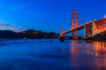 Golden Gate Bridge view from the hidden and secluded rocky Marshall's Beach at sunset in San Francisco, California