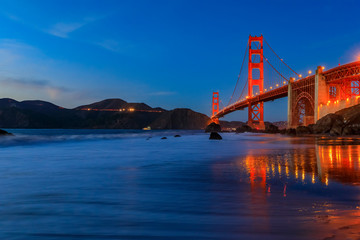 Golden Gate Bridge view from the hidden and secluded rocky Marshall's Beach at sunset in San Francisco, California