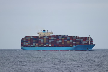 Container cargo ship moving in the ocean.