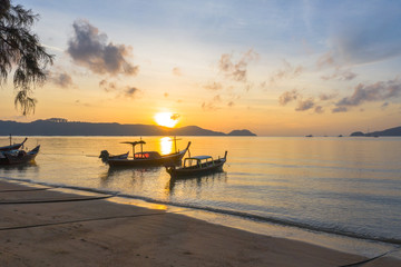 Fototapeta na wymiar aerial view sunrise above fishing boats parking near the beach.