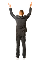 Full length of businessman stnading on white background with raised arms. Back view.