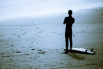 Surfing silhouette surfer man wearing wetsuit surf in tamraght taghazout agadir morocco 