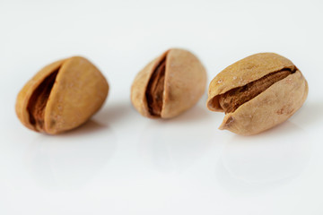 salted pistachio nuts isolated on white background