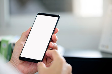 man using smartphone with blank screen for graphics display.
