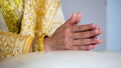 bride hands on manner of respect in Thai wedding ceremony - 285386951