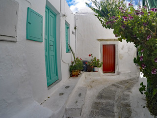 Blue and red door next to white walls at Mykonos