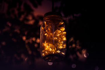 lights from led in a glass jar with nature background,Concept decoration vintage style.