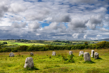 Merry Maidens of Boleigh neolithic stone circle with green farm fields in Cornwall England