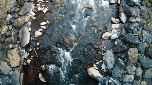 Overhead shot of a mountain stream in a stoney riverbed